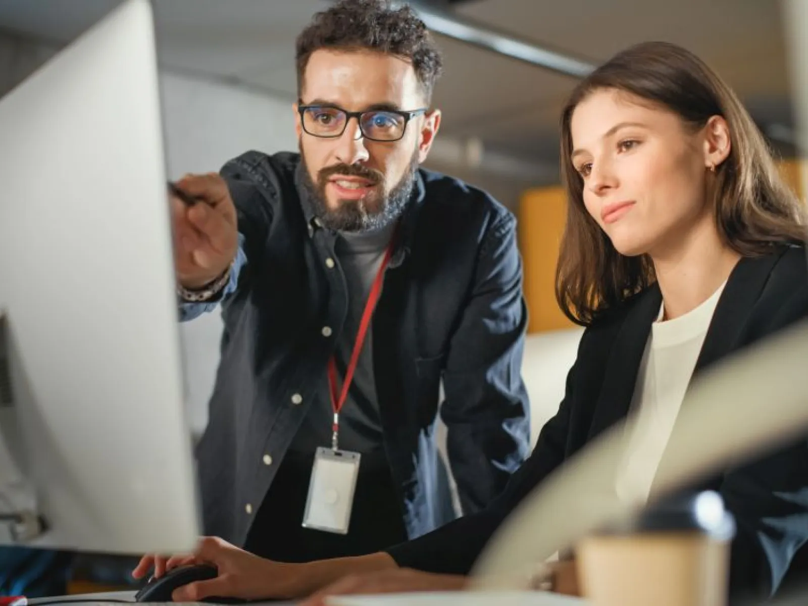 a man and a woman looking at a computer screen
