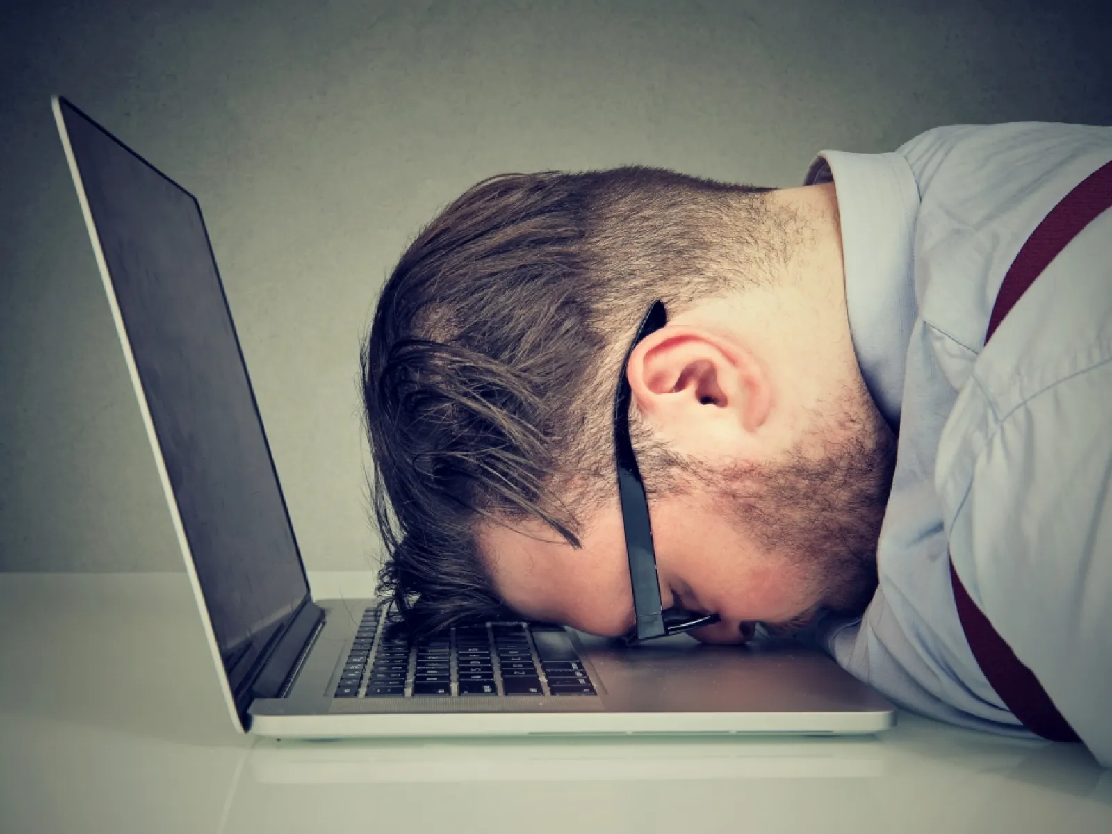a person sleeping on a laptop
